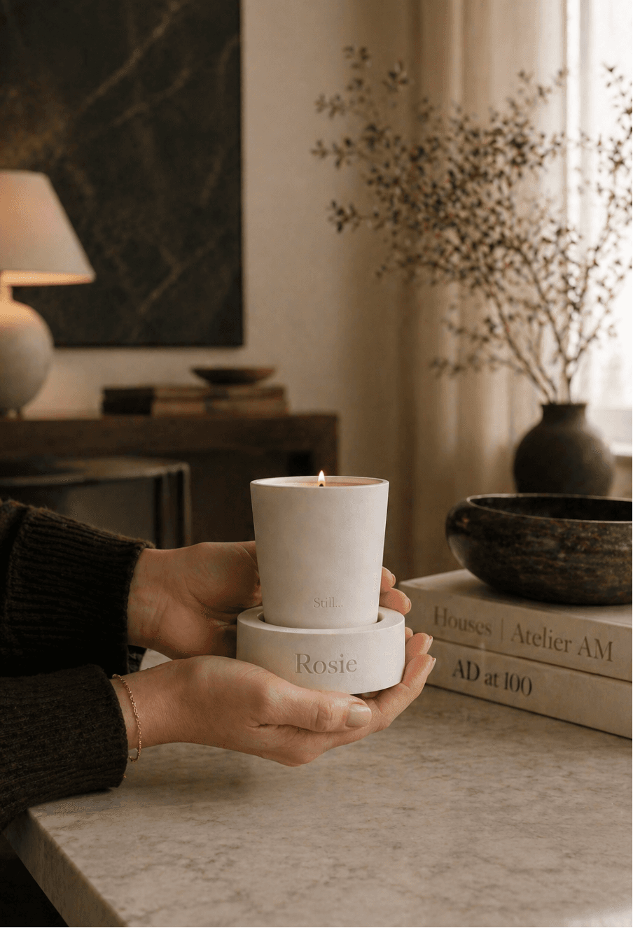 A Still… candle held in two hands